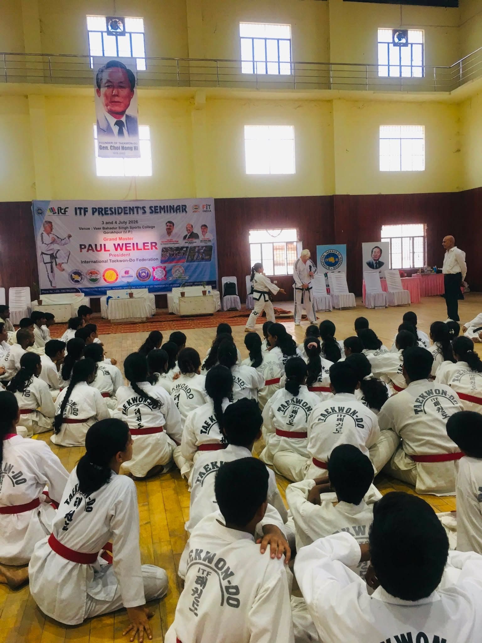 Students seated on the hall floor during a session at the ITF President's Seminar